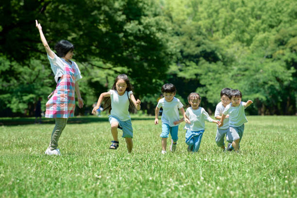 istock Children running and a woman watching 1666755965