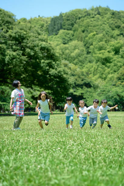 istock Children running and a woman watching 1666758140