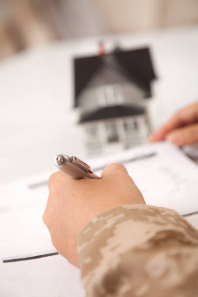 istock US Marine Female Soldier Holding a  Small House 166676143