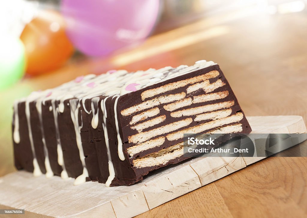 A layered chocolate cake with icing on a plate a chocolate cake. made for a children's birthday party. Dog Stock Photo