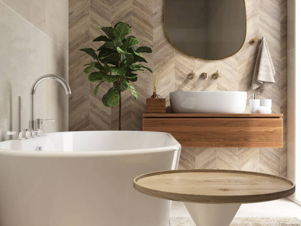 istock Round wooden side table, bathtub, fiddle leaf fig tree in luxury design bathroom in sunlight on beige brown tile wall 1666766765