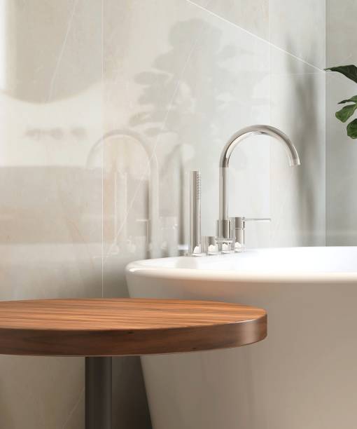istock Round wooden side table, bathtub, fiddle leaf fig tree in luxury design bathroom in sunlight on white tile wall 1666766766