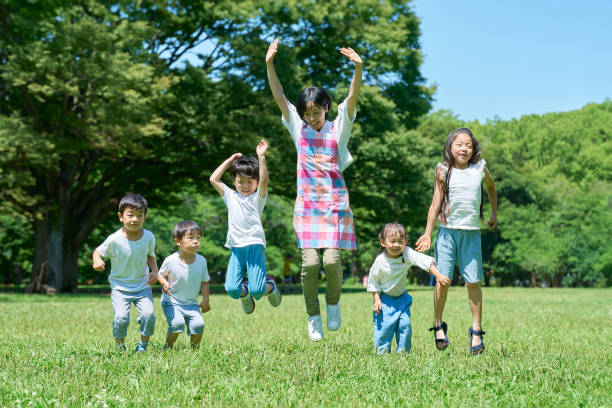 istock Children and a woman jumping 1666766853