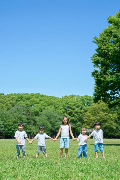 istock Children holding hands in a row 1666769974