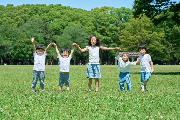 istock Children holding hands in a row 1666770517
