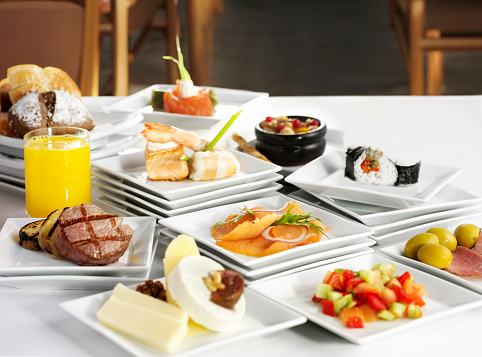 Open buffet table full of all kinds food in a restaurant