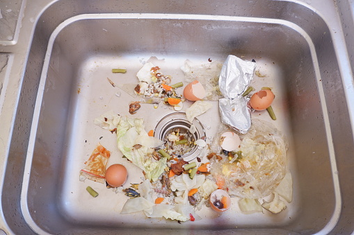 the sink is clogged with food residue. food waste can be used as natural compost
