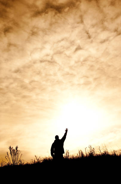 istock Man On Knees in Praise and Worship Silhouette 166678500