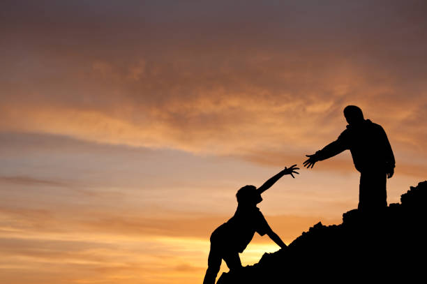 istock Teamwork Concept of Boy Assisting Another Silhouette 166678568