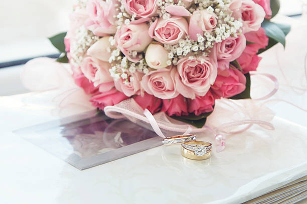 istock diamond & gold  wedding ring on a photo album 166678704