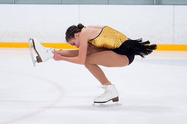Skater artist performing a spin Figure skater in a tight spin figure skating stock pictures, royalty-free photos & images