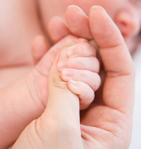 istock closeup child and parent hands 166678926