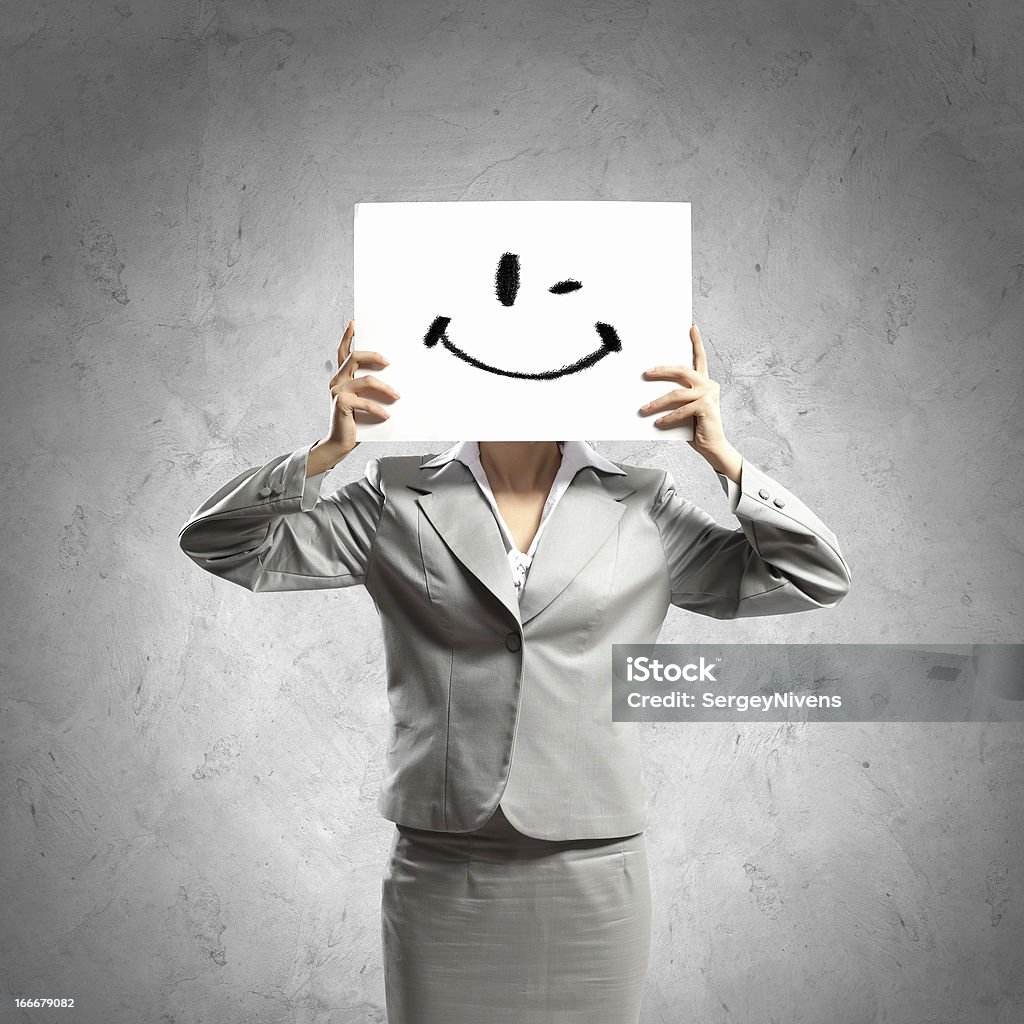 Business woman with drawing Image of businesswoman holding drawing against face. Conceptual photo Adult Stock Photo