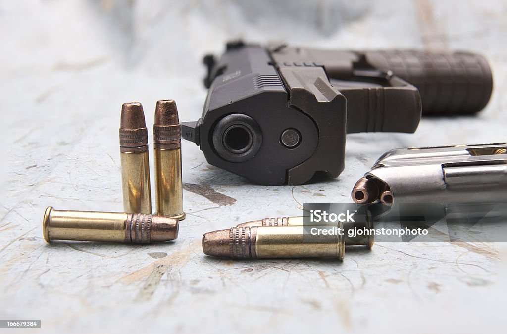 Bullets and a pistol. A close up of a hand gun with bullets and a magazine. Ammunition Stock Photo