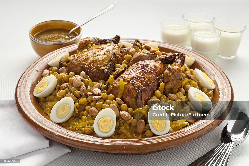 Moroccan couscous with chicken and caramelized Onions Couscous Tfaya, Moroccan Couscous with chicken and caramelized Onions, almonds and hard boiled eggs Couscous Stock Photo