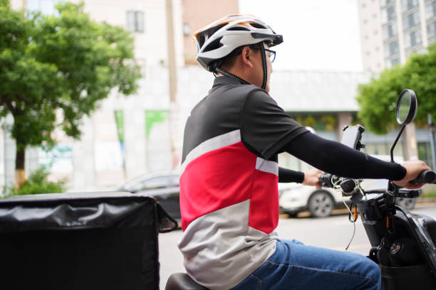 istock Food delivery boy riding an electric bicycle 1666861969