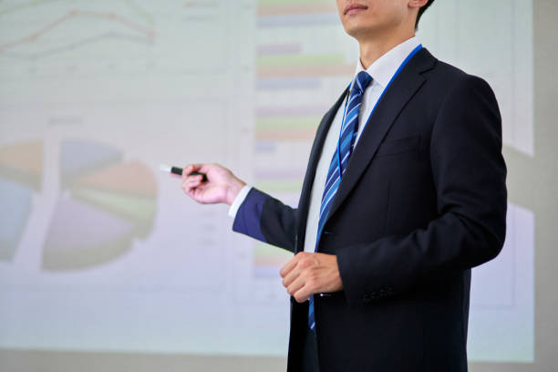 istock Japanese businessman wearing a suit giving a presentation 1666867536