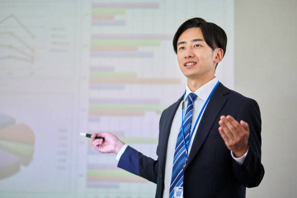 istock Japanese businessman wearing a suit giving a presentation 1666867537