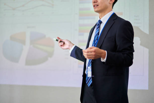 istock Japanese businessman wearing a suit giving a presentation 1666867540