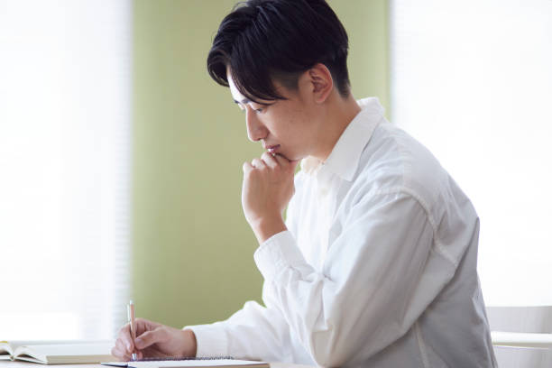 istock Japanese male university student studying in the university library 1666867668