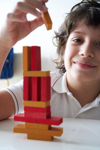 istock Cute Little Boy Playing with wooden block 1666868074