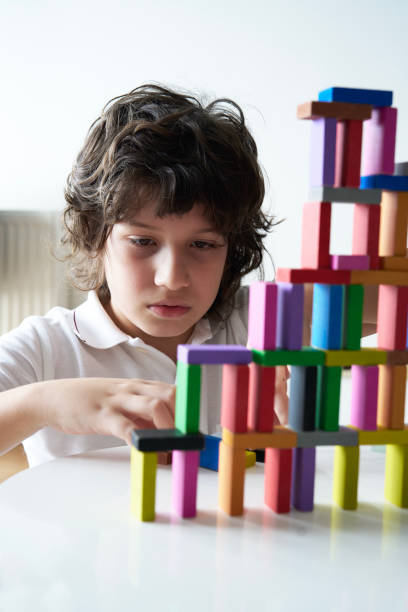 istock Cute Little Boy Playing with wooden block 1666869363