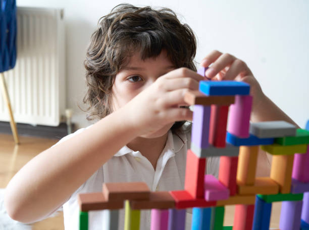 istock Cute Little Boy Playing with wooden block 1666870730
