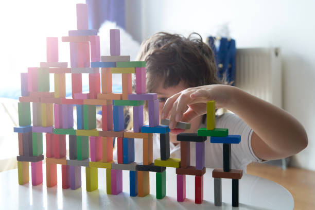 Cute Little Boy Playing with wooden block