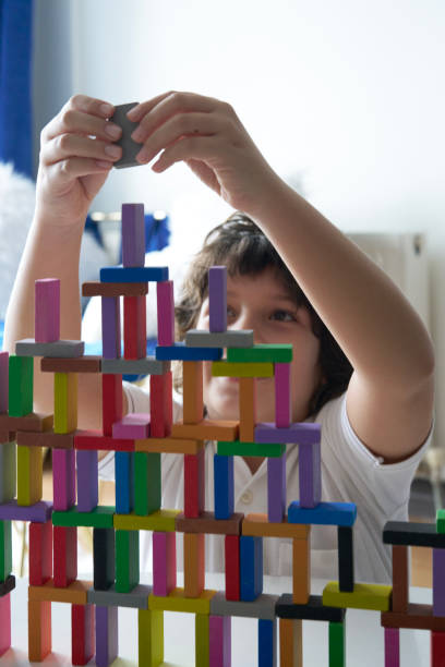istock Cute Little Boy Playing with wooden block 1666872407