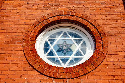 This is a window with the Star of David in the window of a brick church in Macon, Georgia.