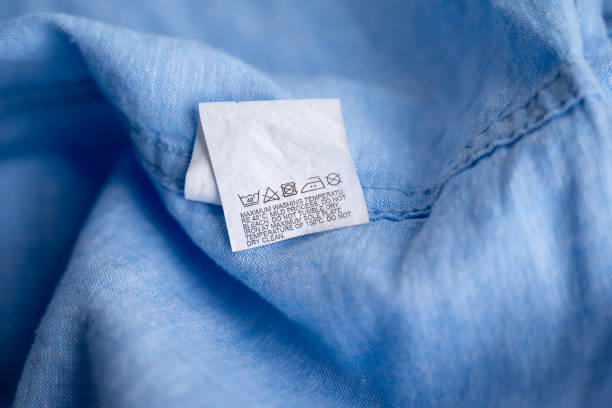 istock Clothing label on light blue garment, top view 1666996167