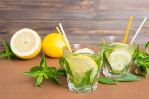 istock Mojito summer refreshing cocktail with ice and mint. mojito cocktail with lime, lemon and mint in a tall glass with a stick 1667001020