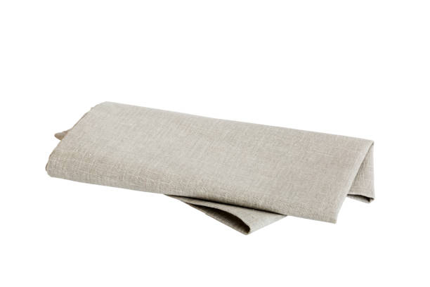 istock Grey textile napkin isolated on white background. Folded decorative kitchen cotton towel. Top view 1667001097