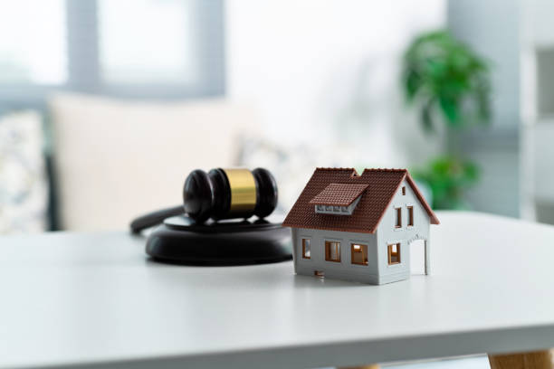 Model house and gavel on the table stock photo