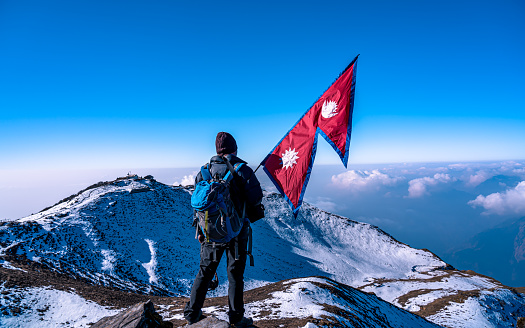 Tourist enjoy to showing Flag in the air during Mardi Trek in Kaski, Nepal, on  Saturday February 13, 2021