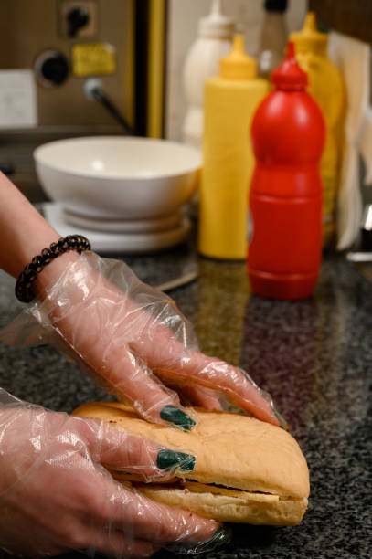 istock Preparation of panini, bread with sauces, cheese and meat for panini. 1667025794