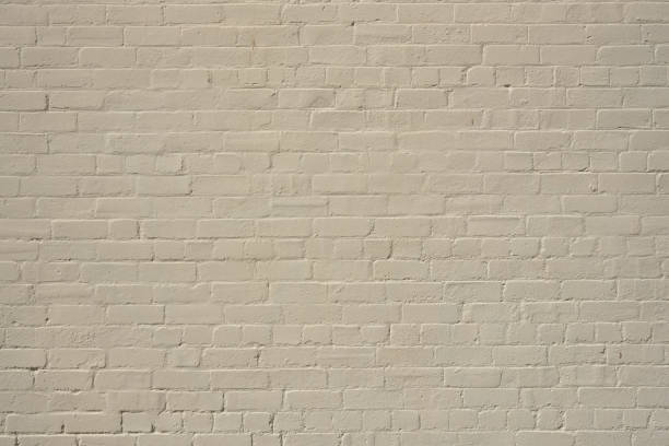 istock Part of a painted old beige brick wall 1667027899