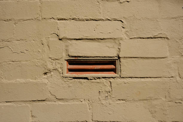 Ceramic air duct in a brick wall.
