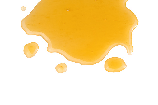 Spilled honey isolated on white background.