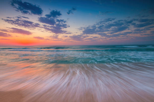 istock Beautiful sunrise over the sea shore beach 1667052982
