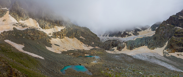 mountain ridge with glacier in dense mist