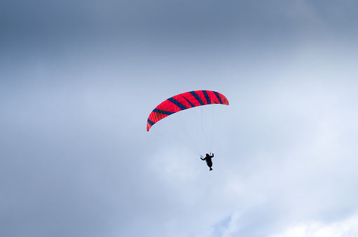 Altstatten, Switzerland - July 4, 2023: A paraglider flying in cloudy bad weather