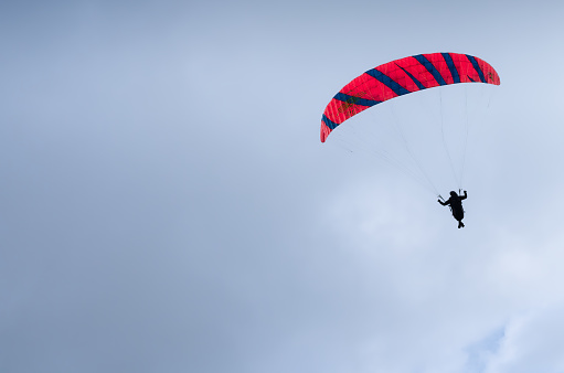 Altstatten, Switzerland - July 4, 2023: A paraglider flying in cloudy bad weather