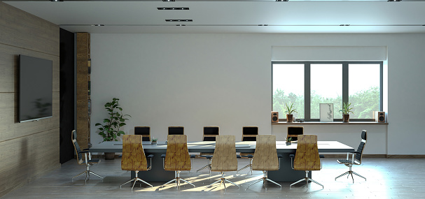 Large conference table with chairs in a meeting room in the high-rise office building, view of the skyline