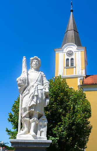 Lenti, Hungary - July 15, 2023: A white statue of Saint Florian, the patron saint of firefighters