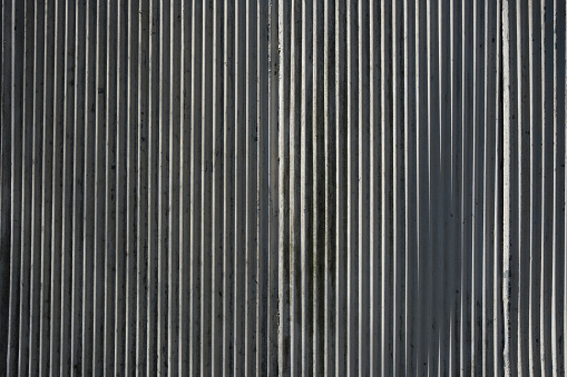Corrugated iron fence detail on a sunny day.