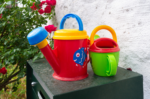 Werdenberg, Switzerland - July 4, 2023: Children colorful watering cans