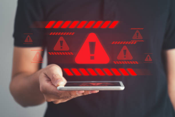 istock Businessman pointing download button with red warning alert system hacked screen. System alert for virus,spam,scam and phishing. Cyber security, data security system concept. 1667139964