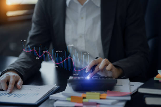 istock Business hand using calculator with financial data and marketing growth report graph and data interface science. 1667149140