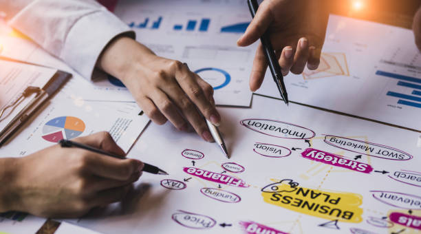 istock Group of  business hands with business financial documents. 1667151715